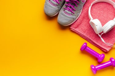 flat-lay-frame-with-pink-items-on-yellow-background